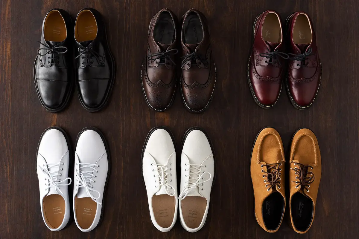 Flat lay of men's shoes: oxfords, brogues, loafers, chelsea boots and sneakers